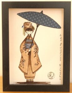 tableau encre et papier dans un cadre vitrine petit format représentant un personnage appelé Poupir Kokeshi dans sa tenue traditionnelle japonaise.
